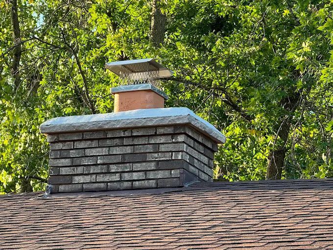 Finished brick chimney fitted with a stainless multi-flue cap