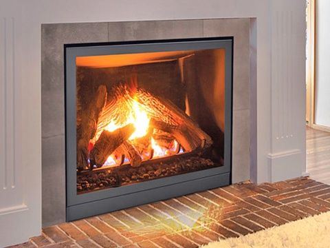 Modern gas fireplace with a grey stone surround and a brick hearth